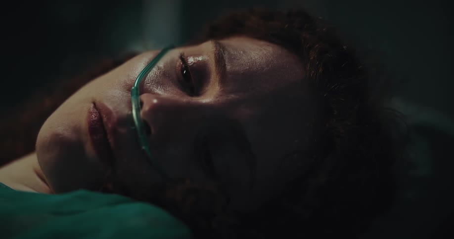 Closeup on the face of a female patient with a sad facial expression and a nasal cannula