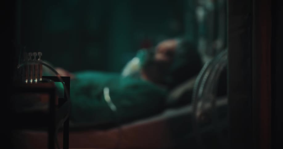 A woman with a breathing mask sleeping or unconscious in a hospital bed
