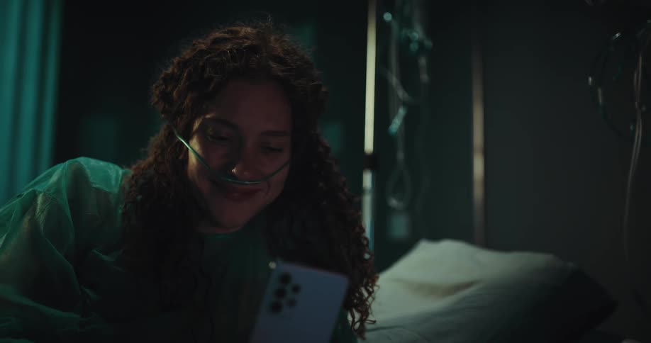 Hospital patient smiles while viewing smartphone screen