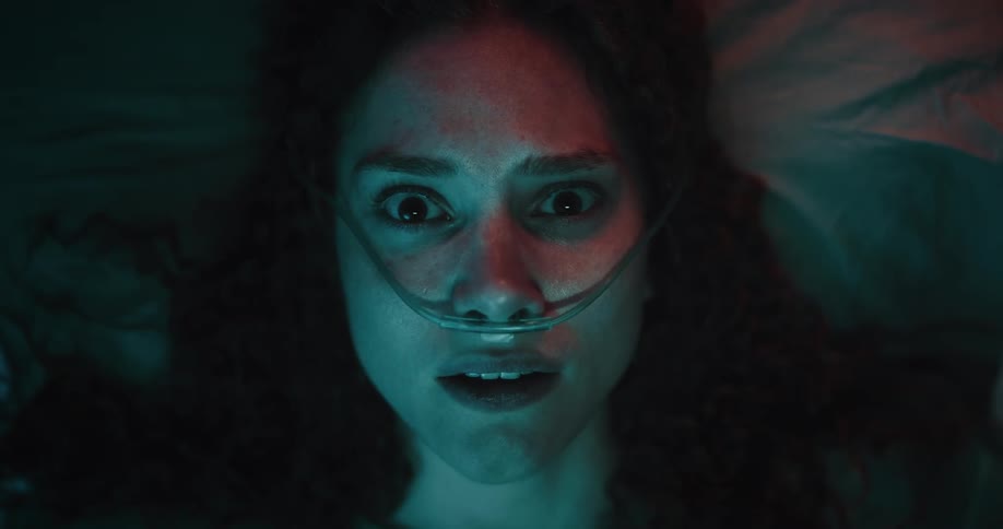 The woman with the oxygen tube on her face wakes up and is looking around scared