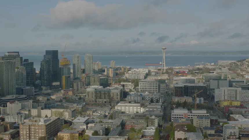 Moving past a large city with many buildings