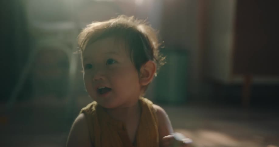 Baby girl sitting and clapping happily