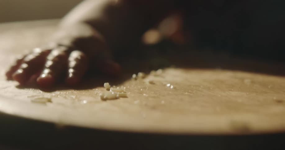 Female baby banging her hands on the table with food