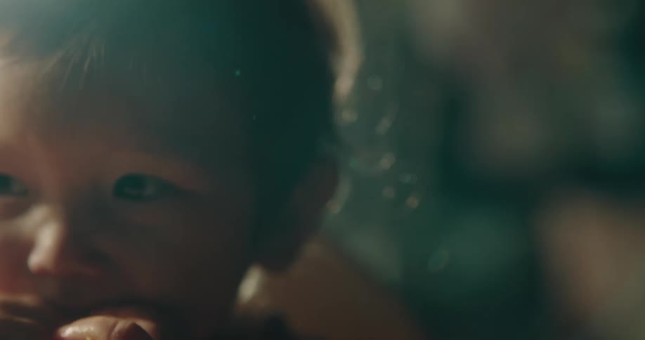 Close up of toddler eating food sitting in chair