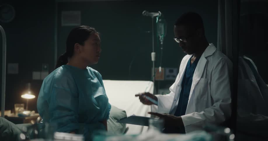 Doctor running hands over a female patients neck and checking the medical record