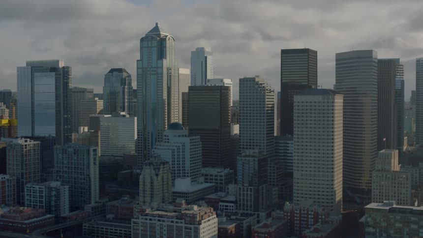 Tall buildings line a cloudy sky