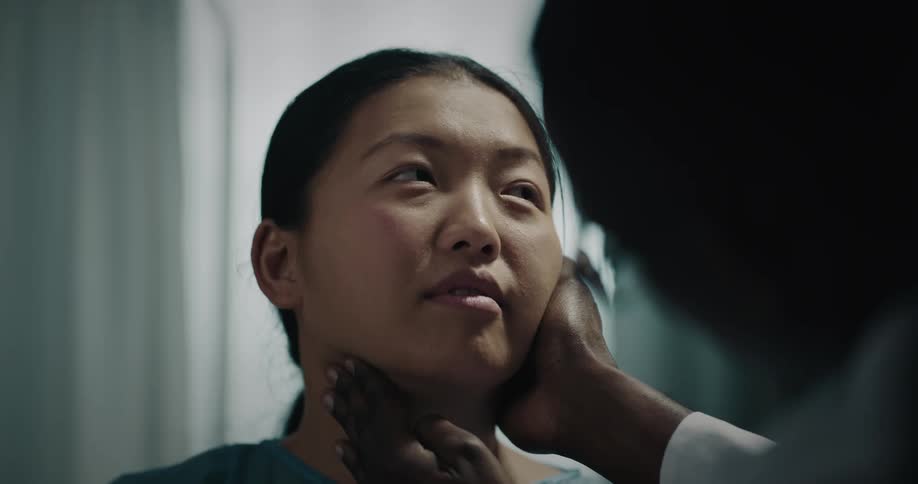 Doctor performs a checkup on the neck of a patient