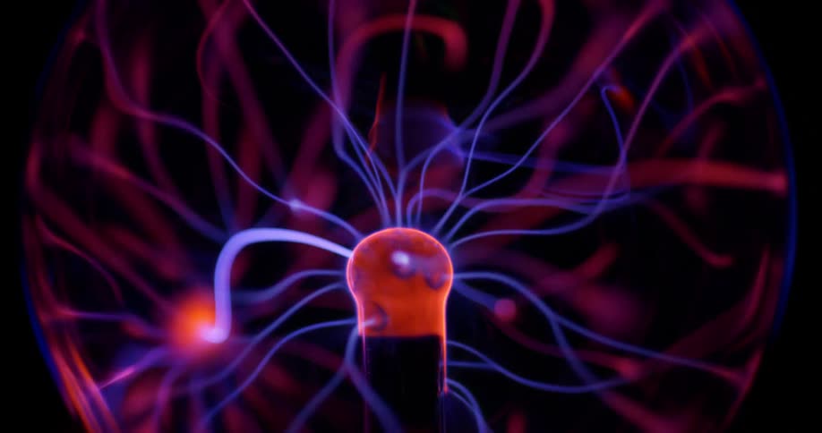 Glowing purple wisps move inside an orb of electric energy from a phosphorescent pink object