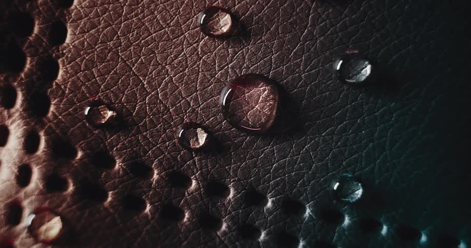 Drop of water spread across a red leather