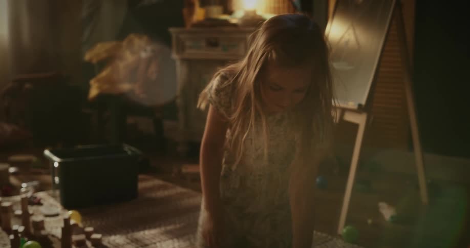 A little girl playing with toys in the room