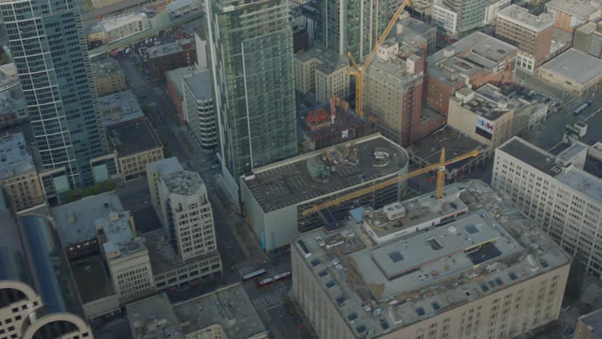The city below has many tall buildings near the shore