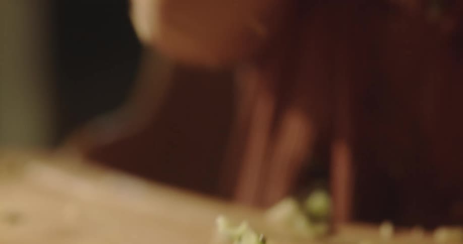 Close up of a toddler eating a kiwi and clapping hands