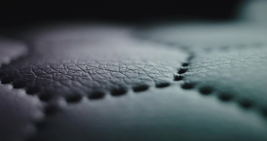 A leather fabrics close up with sewing holes