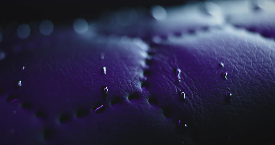 Several drops of liquid on a surface with some seams in a geometric shape