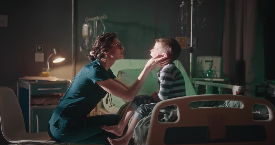 A clip of a nurse attending to a kid in the hospital ward room