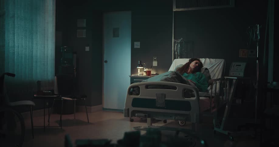 Female patient lying in a hospital room sleeping