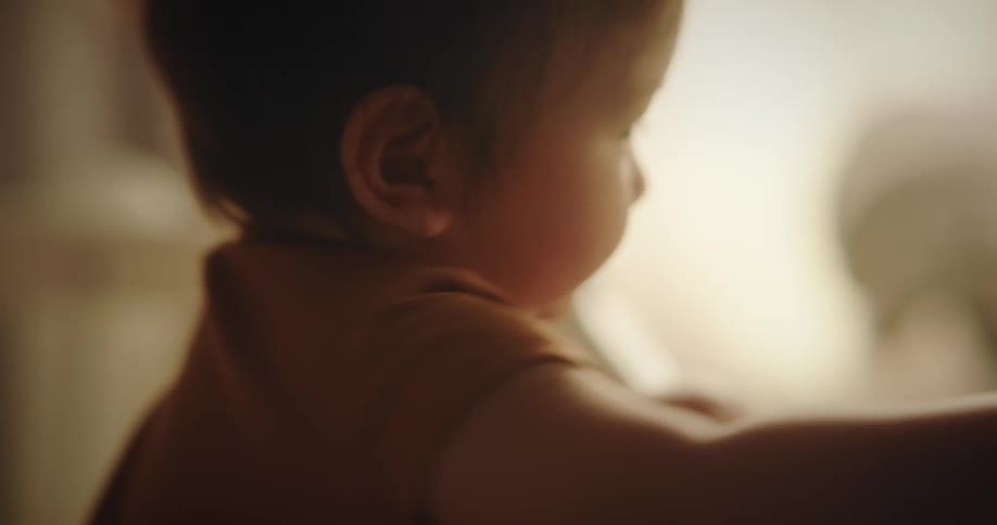 Closeup of a young child in a crib with a blurred background