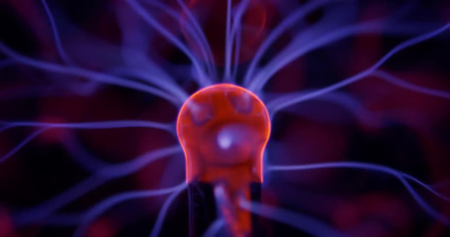 Glowing purple wisps extend and waver into pink illuminated energy from a phosphorescent pink object