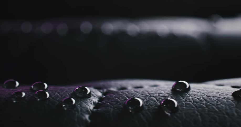 A leather fabric with drops of water on top spread across it