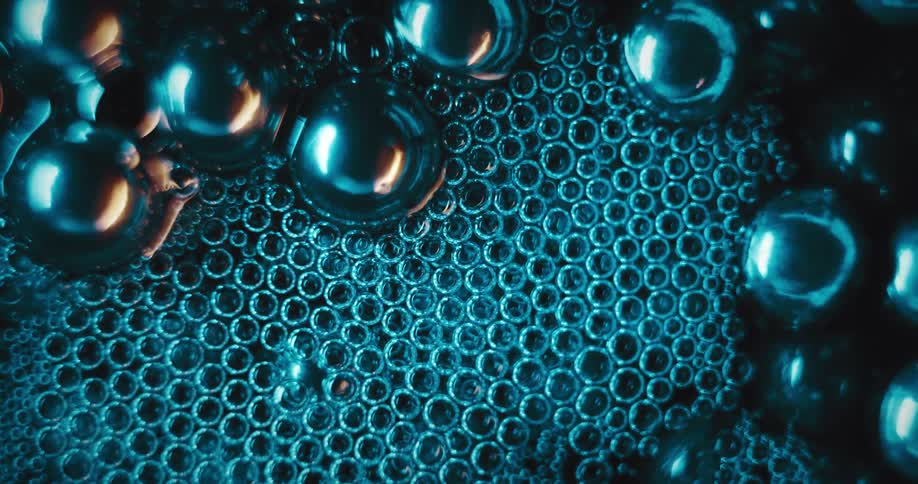 Close up of silver bubbles floating in liquid