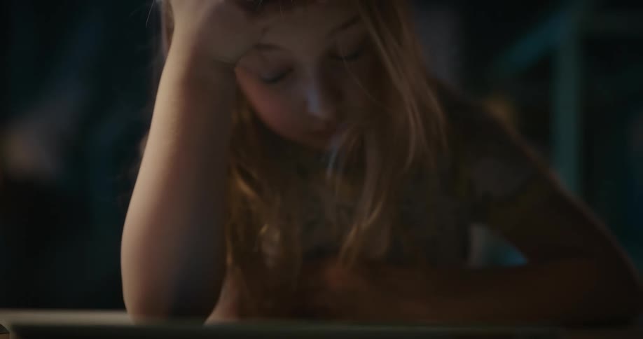 Young girl typing on a tablet and getting frustrated