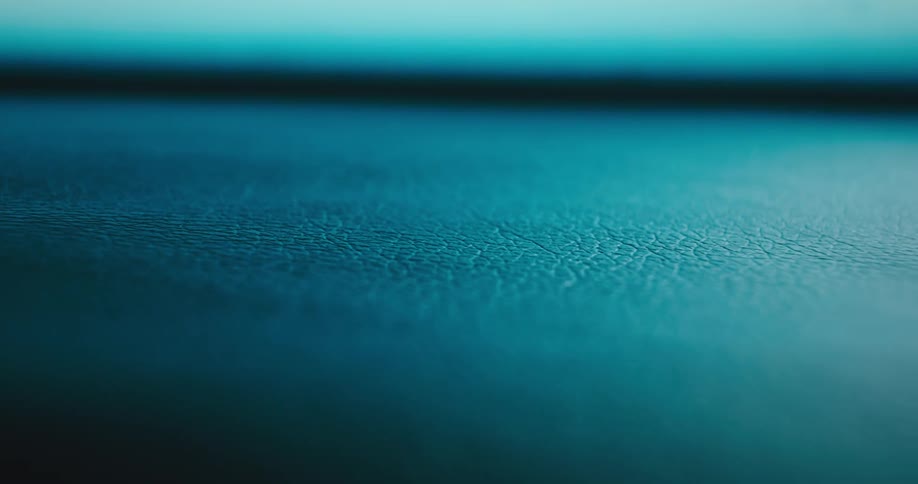 Cose up of textured leather under blue lights