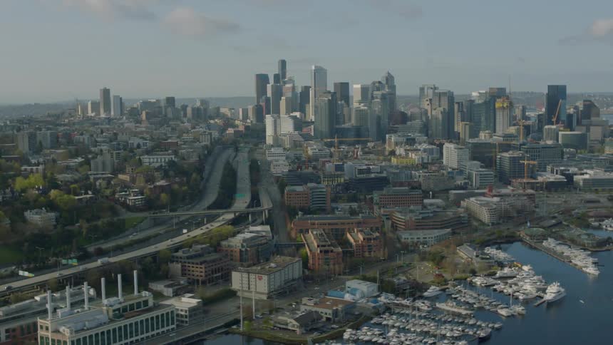 Vehicles travel on a road leading to a large city