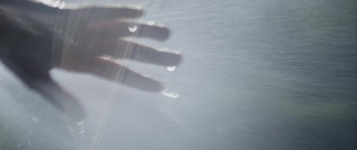 Hand waving under a strong spray of water