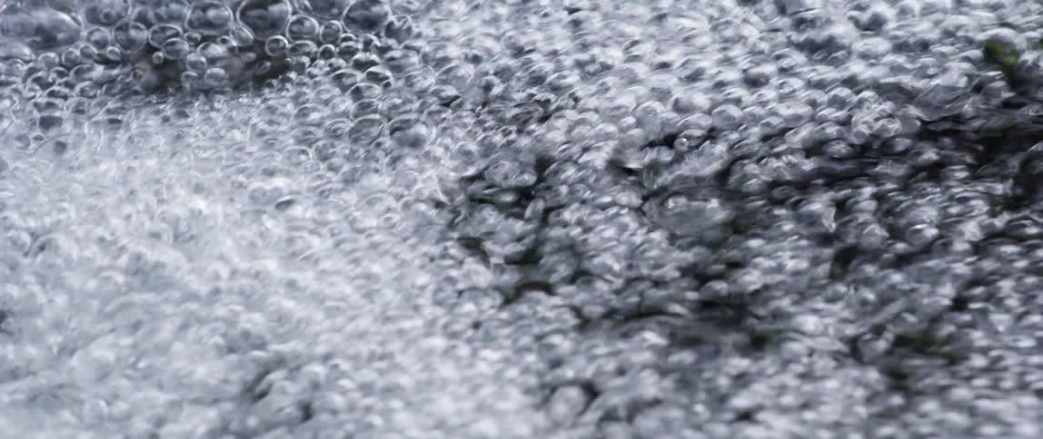 View of river water flowing with bubbles