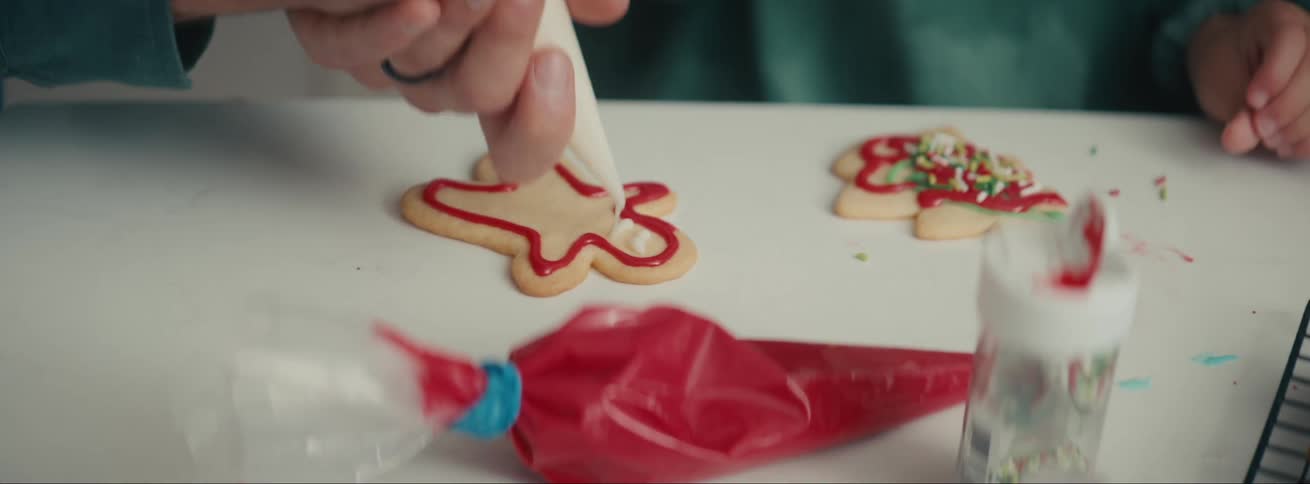 People decorating christmas cookies