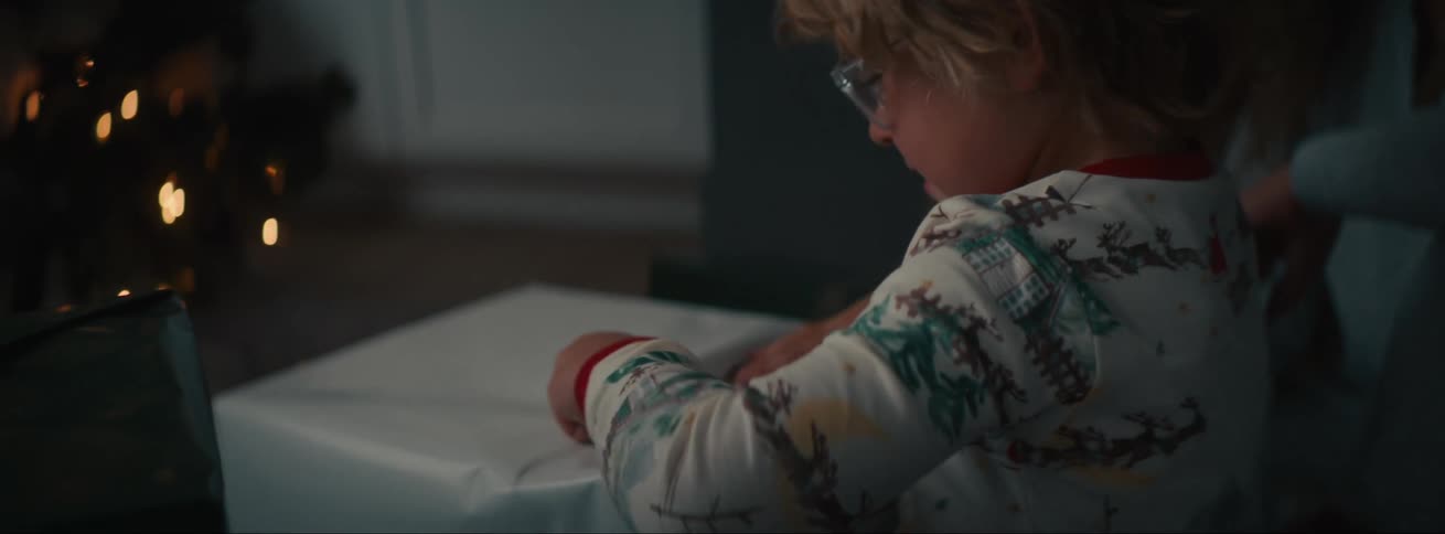 Boy opening a present in the living room