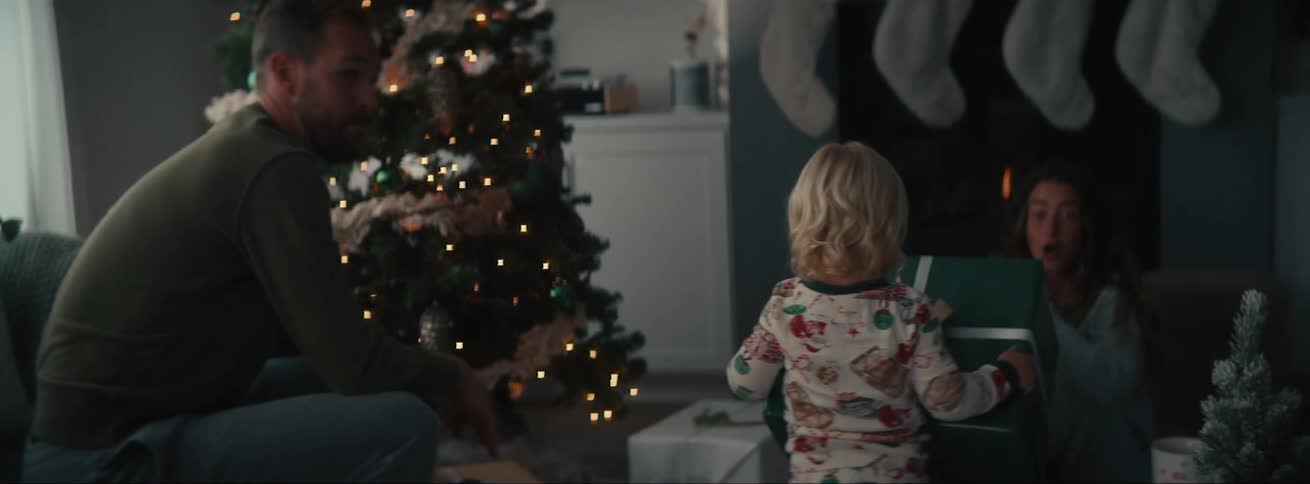 Father and children opening christmas presents