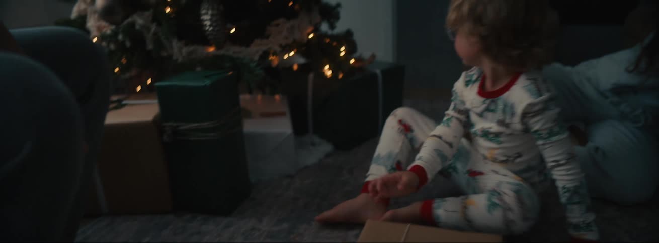 A clip of the family unboxing their gifts near the christmas