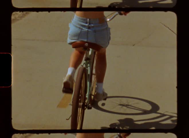 A clip of a lady cycling beside the beach
