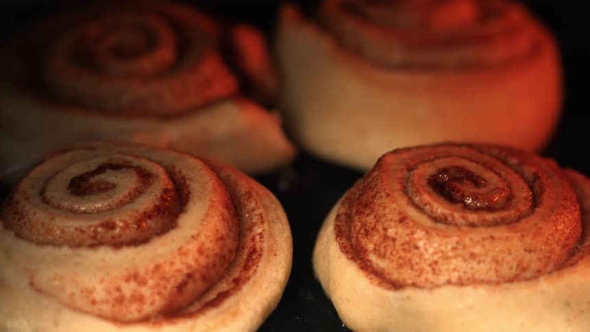Extreme closeup of small sweet pastries in slices being baked in the oven