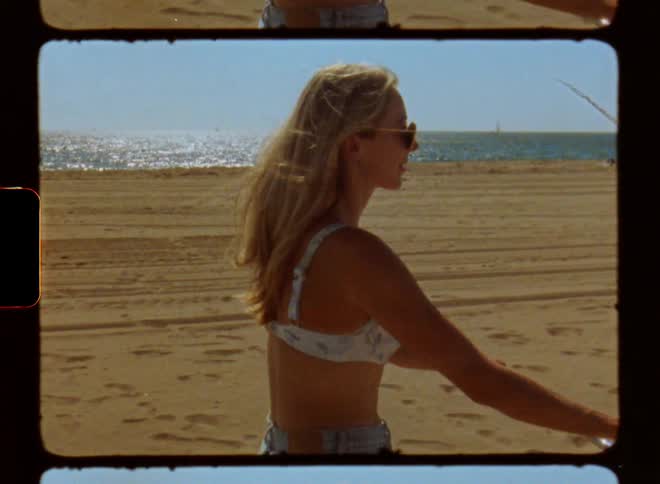 Portrait of a woman riding a bicycle on the beach sand