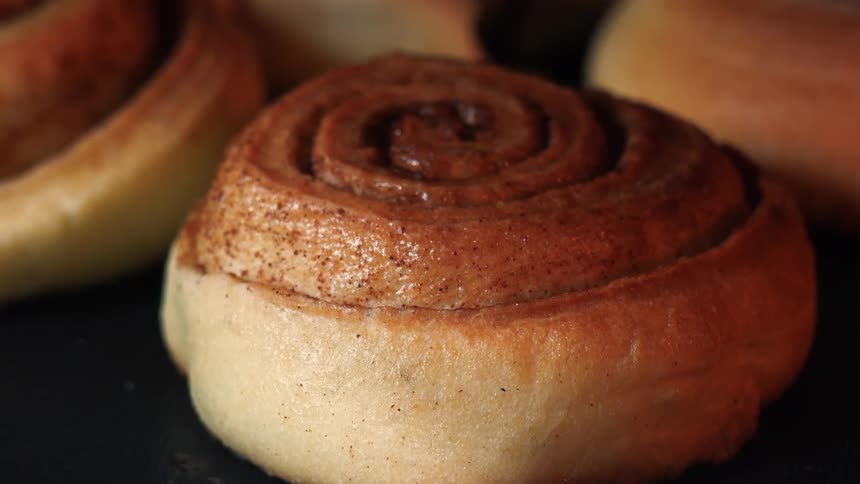 Cinnamon roll on black background