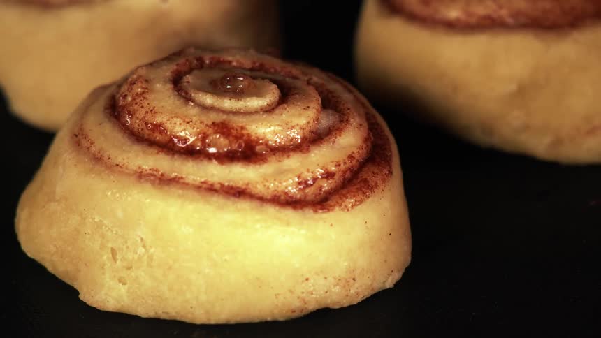 The cinnamon buns slowly rise in the oven