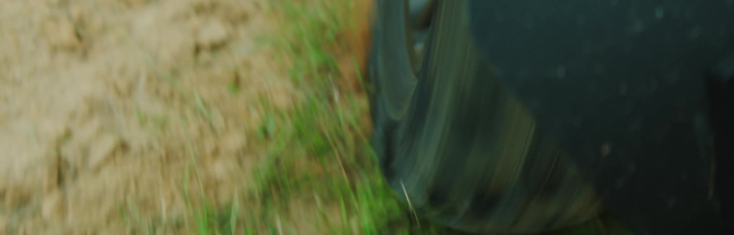 Wheel of a vehicle on sand and grass soil