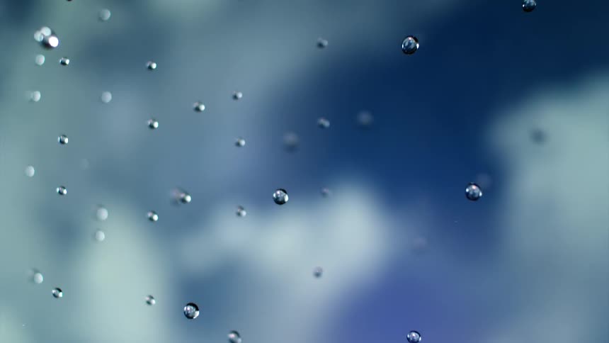 Clear droplets fall against blue and white background