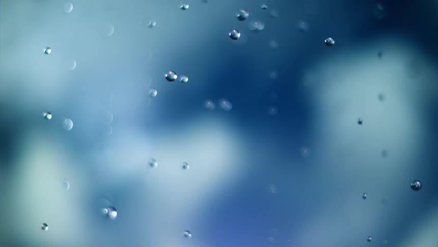 Extreme closeup of water droplets falling