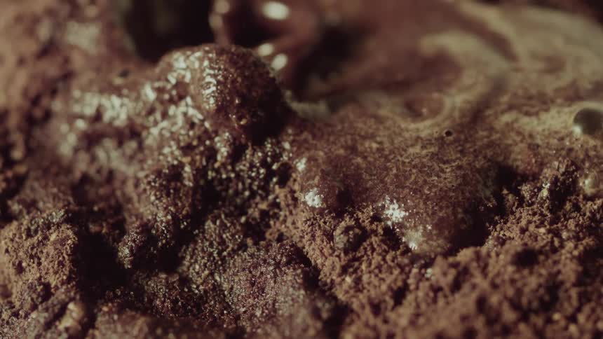 Liquid splashes onto brown cake mix