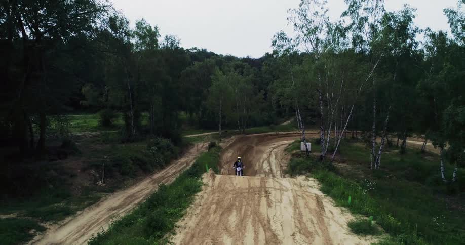 Motocross rider performing high jump at the track