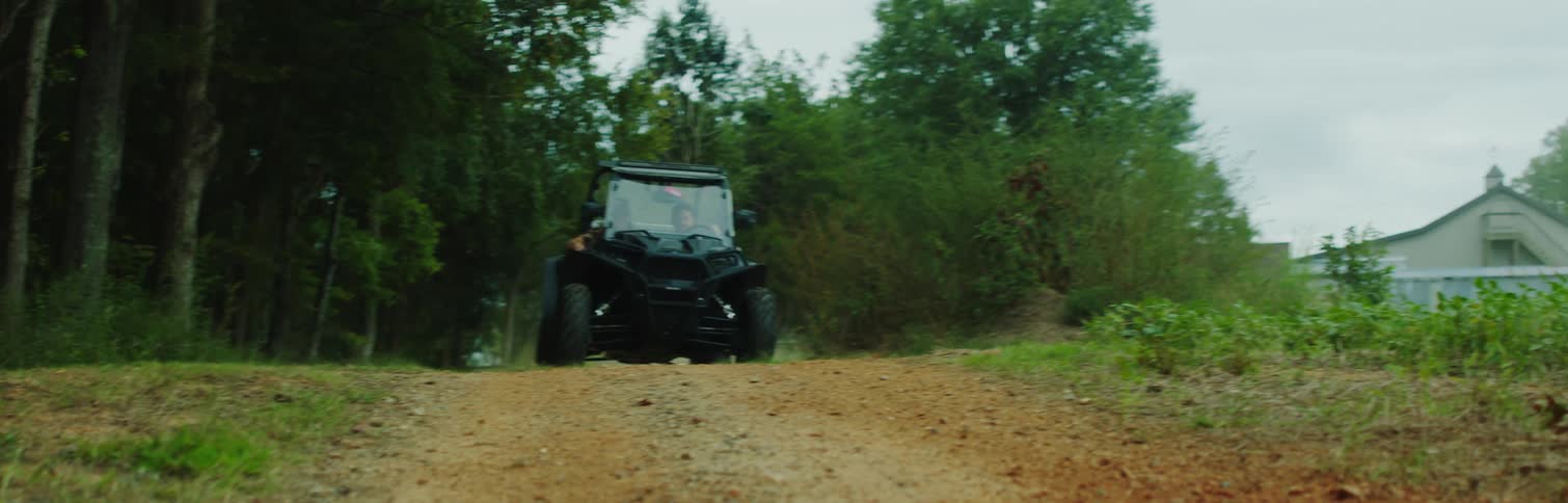 An offroad car is passing through a dirt street
