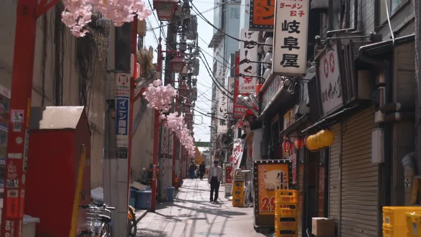 Alley in a japanese neighborhood in the middle of the city with signs