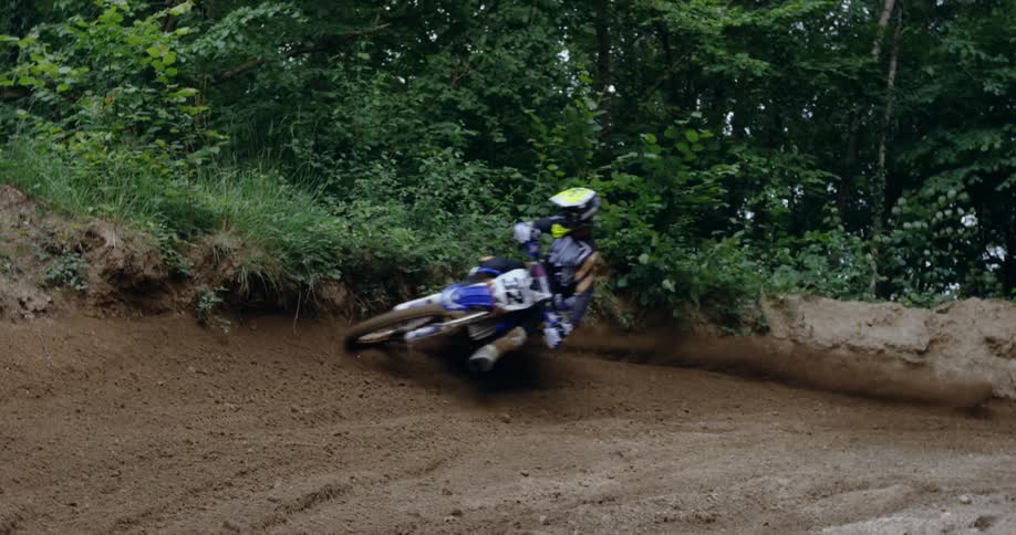 Person riding a motorcross dirt bike on a track