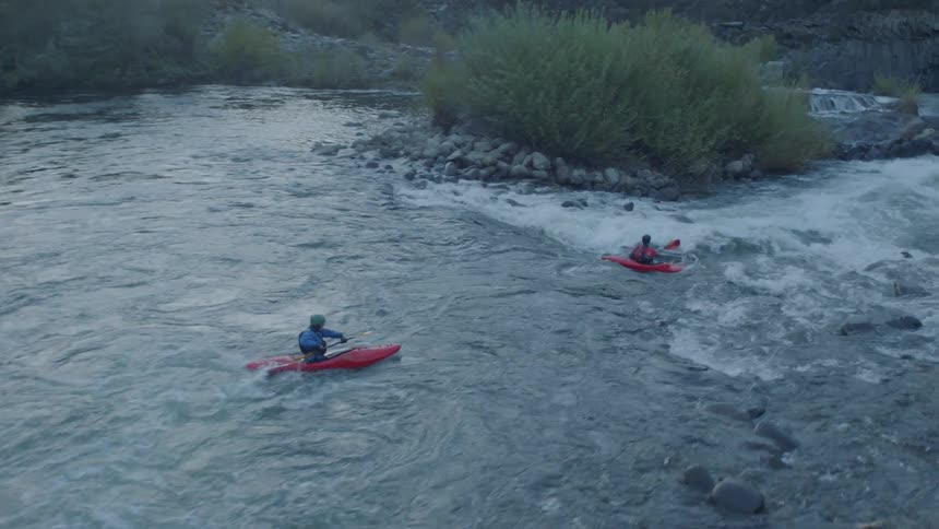 Following kayakers as they navigate increasingly extreme rapids