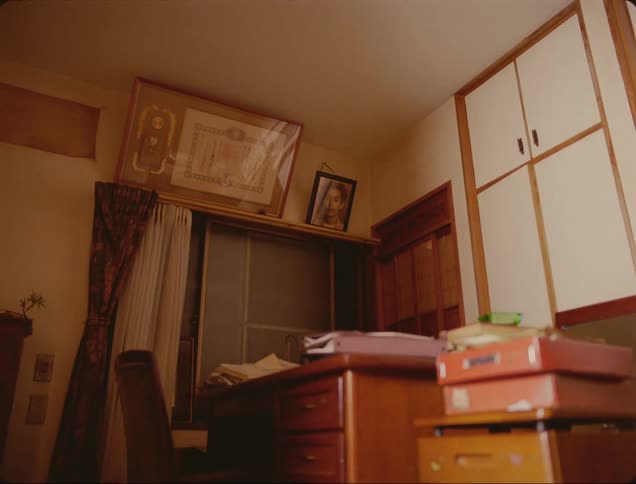 Sunlight plays across small office containing wood desk