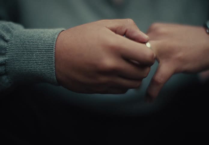 A person is touching their engagement ring