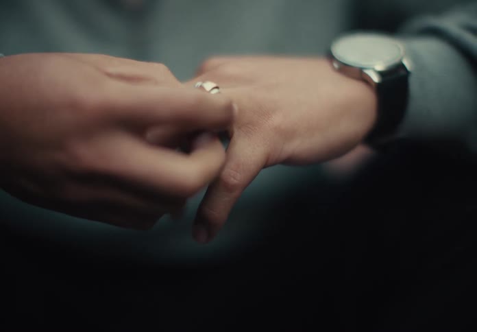 A man moving ring round his finger